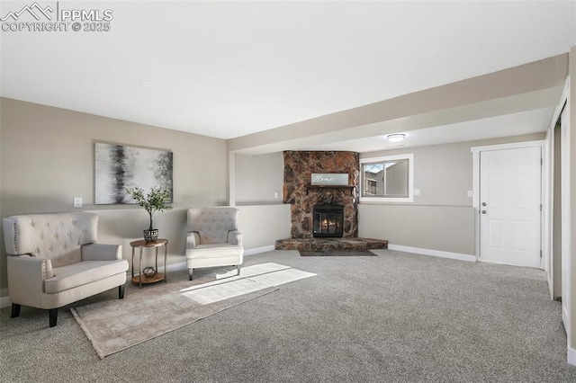 unfurnished living room with a stone fireplace, carpet, and baseboards