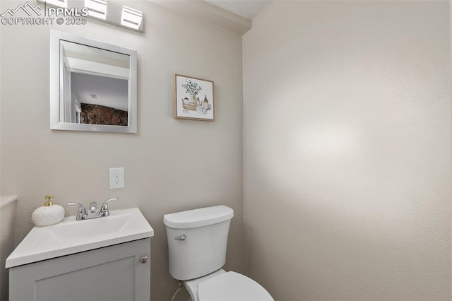 half bath with vanity and toilet