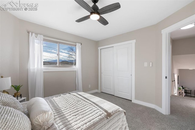 bedroom with baseboards, a closet, a ceiling fan, and light colored carpet