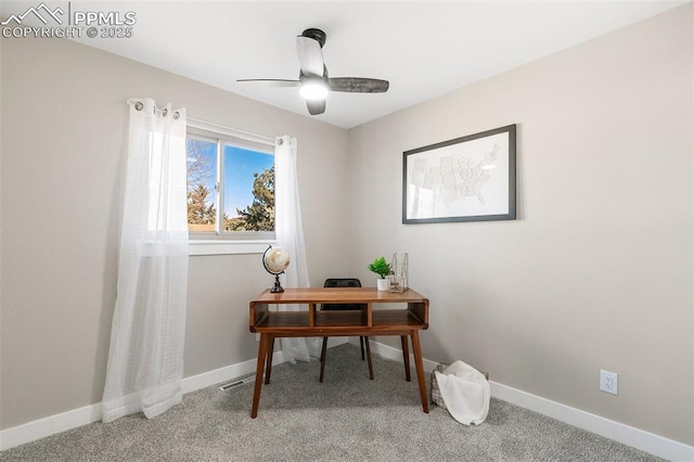 carpeted office featuring ceiling fan and baseboards