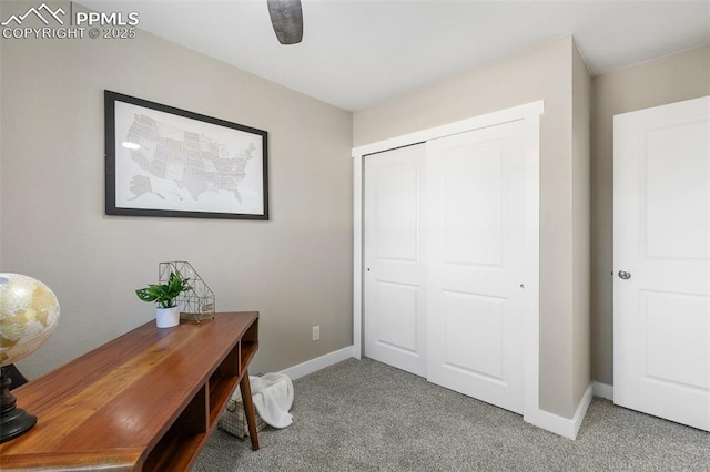 office area featuring light carpet and baseboards