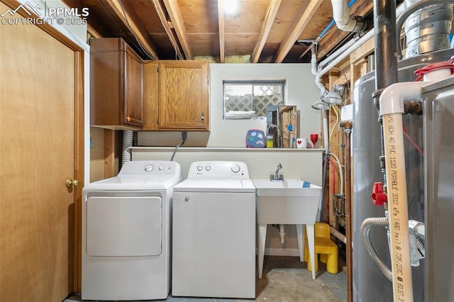 laundry area with washer and clothes dryer and cabinet space