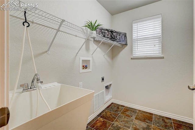 washroom featuring laundry area, baseboards, hookup for an electric dryer, washer hookup, and a sink