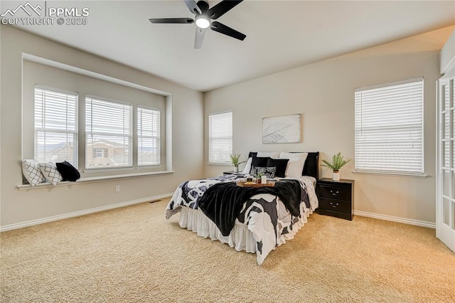 carpeted bedroom featuring baseboards and a ceiling fan