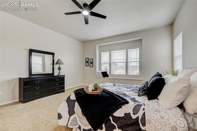 carpeted bedroom with a ceiling fan and baseboards