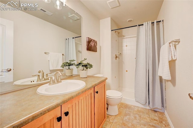 bathroom featuring visible vents, toilet, vanity, and a shower with shower curtain