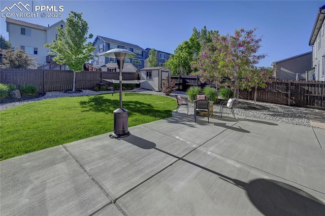 view of patio / terrace with a shed, an outdoor structure, a fenced backyard, and a residential view