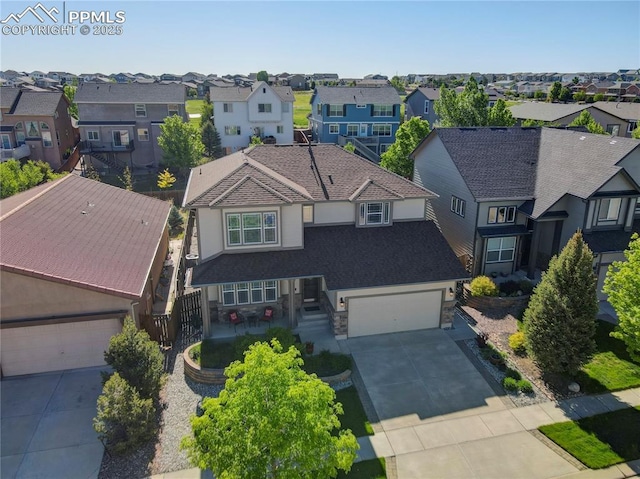 view of front facade featuring driveway, a garage, and a residential view