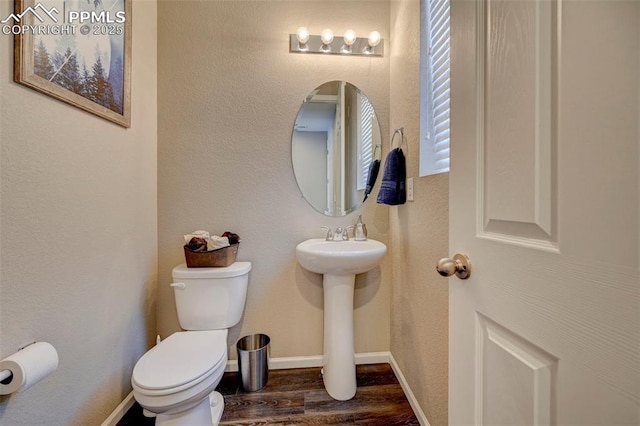 bathroom featuring sink, hardwood / wood-style floors, and toilet