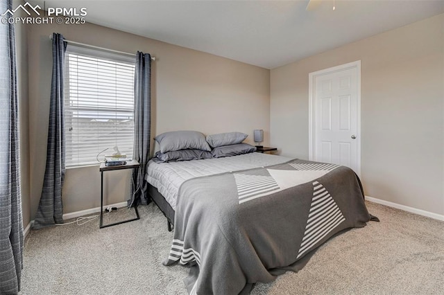 bedroom featuring ceiling fan and light carpet