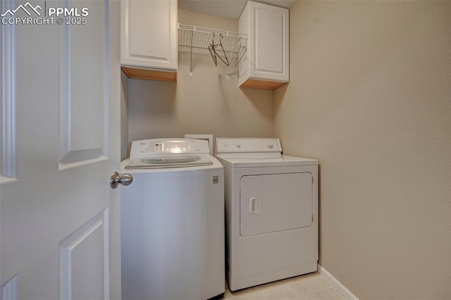 laundry room featuring cabinets and washing machine and dryer