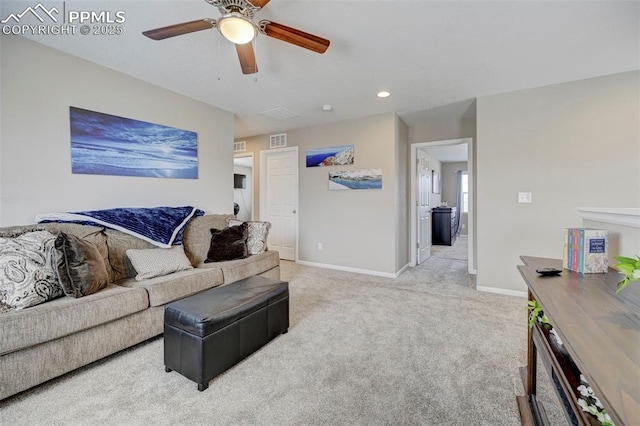 living room featuring light colored carpet and ceiling fan