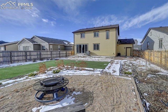 snow covered property featuring an outdoor fire pit