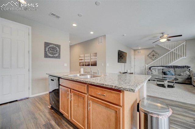 kitchen featuring dark wood-type flooring, sink, a center island with sink, black dishwasher, and ceiling fan