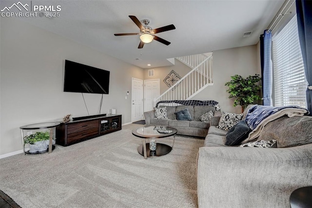 carpeted living room with ceiling fan