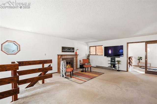 living room with a textured ceiling, a fireplace, and carpet flooring