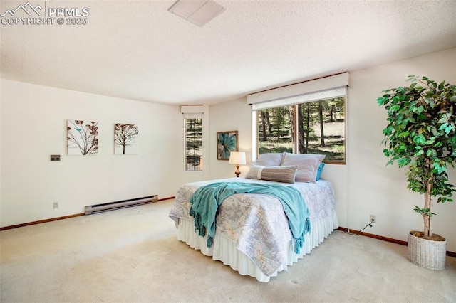 bedroom featuring a textured ceiling, baseboards, baseboard heating, and carpet flooring