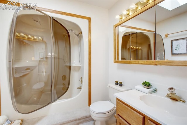 bathroom with vanity, a skylight, an enclosed shower, and toilet