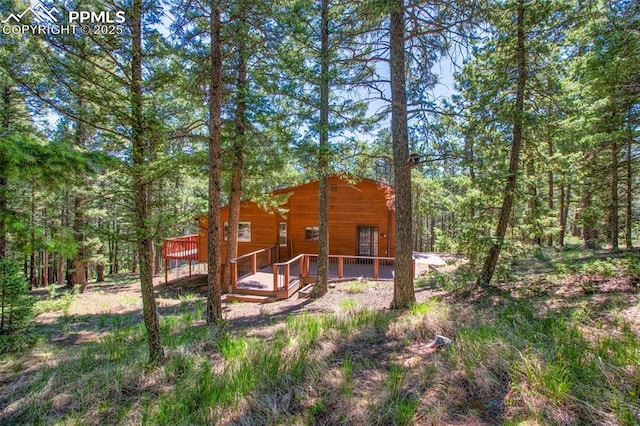 back of house with a wooden deck