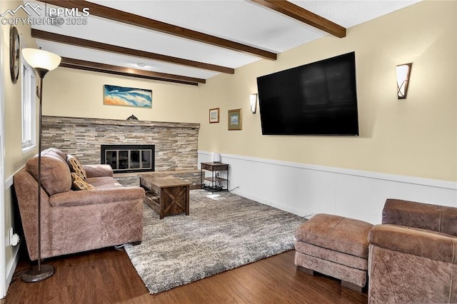 2113 Woodburn St, Colorado Springs, CO 80906 - living room with wood finished floors, beamed ceiling, a fireplace, and wainscoting