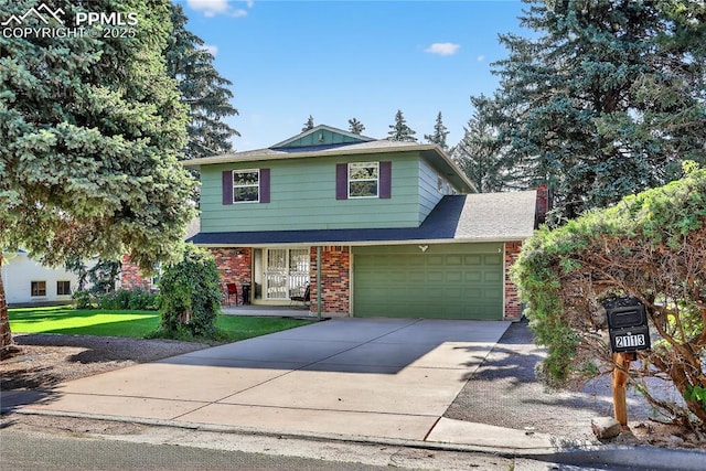 2113 Woodburn St, Colorado Springs, CO 80906 - view of front of home with brick siding, concrete driveway, a front lawn, and a garage