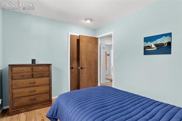 2113 Woodburn St, Colorado Springs, CO 80906 - bedroom with light wood finished floors and a textured ceiling