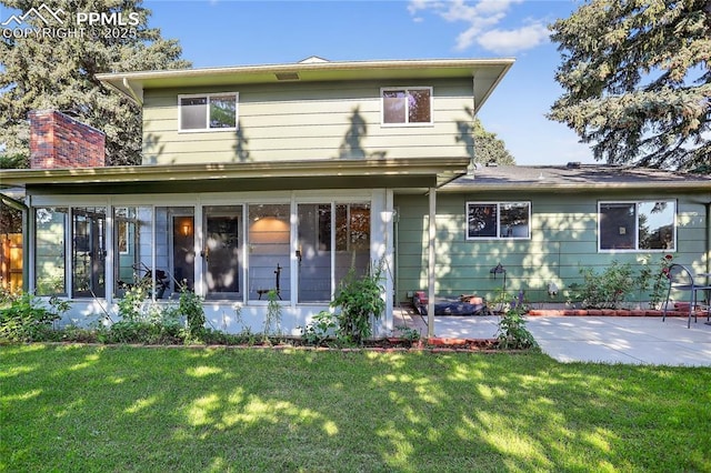 2113 Woodburn St, Colorado Springs, CO 80906 - rear view of house with a patio, a sunroom, a lawn, and a chimney