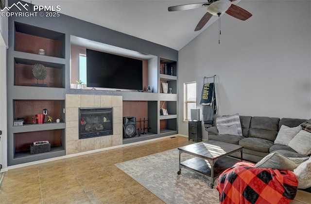 tiled living room with ceiling fan, high vaulted ceiling, built in features, and a fireplace