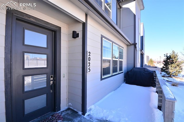 view of snow covered property entrance