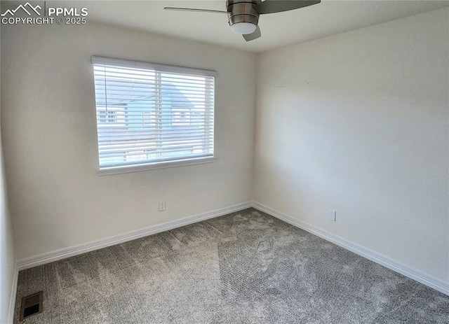 carpeted spare room featuring visible vents, ceiling fan, and baseboards