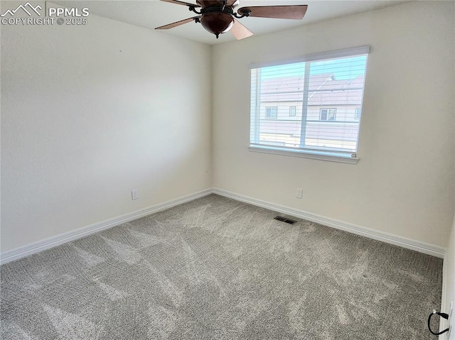 unfurnished room featuring baseboards, visible vents, ceiling fan, and carpet flooring