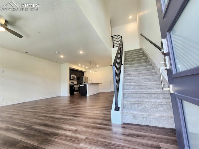 stairs featuring baseboards, visible vents, a ceiling fan, wood finished floors, and recessed lighting