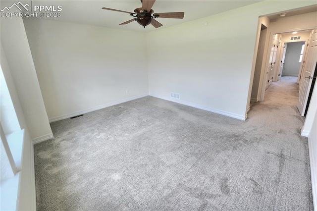 spare room featuring a ceiling fan, visible vents, light carpet, and baseboards