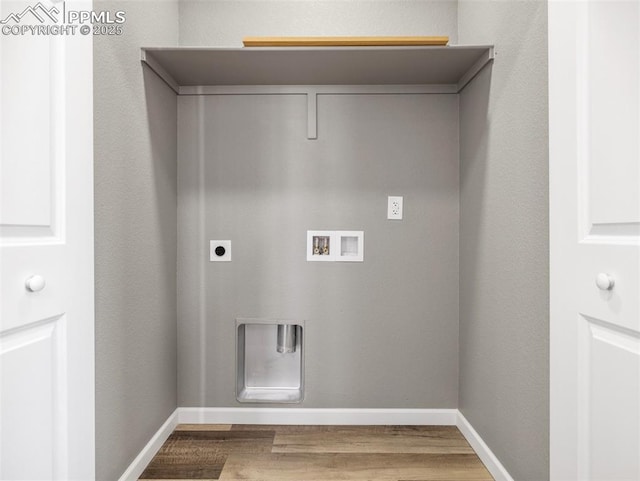 laundry area featuring wood finished floors, electric dryer hookup, baseboards, washer hookup, and laundry area