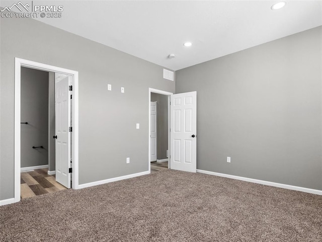 unfurnished bedroom featuring baseboards, recessed lighting, visible vents, and carpet