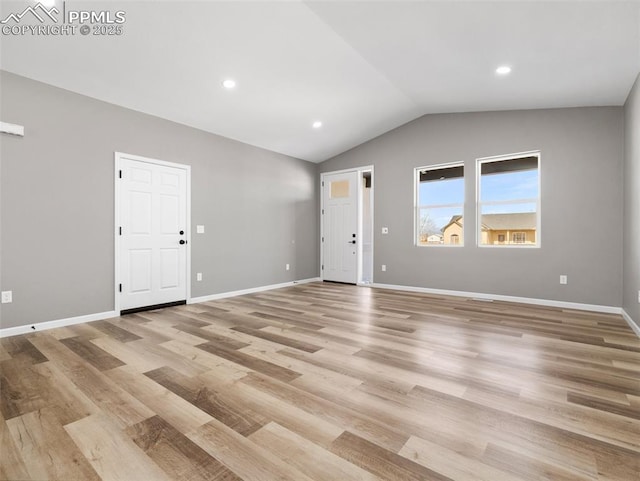 unfurnished room featuring baseboards, light wood finished floors, lofted ceiling, and recessed lighting