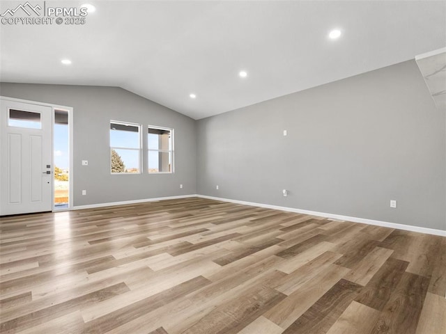 unfurnished living room featuring vaulted ceiling, light wood-type flooring, baseboards, and recessed lighting