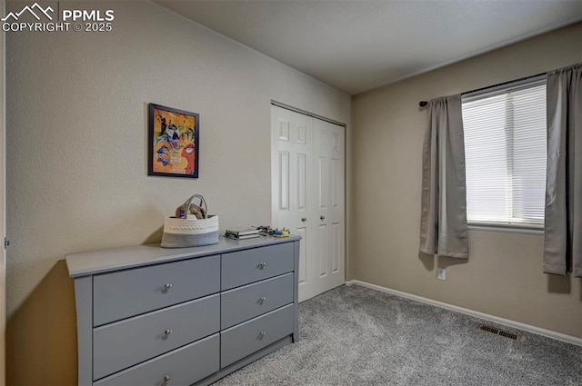 bedroom with light colored carpet and a closet