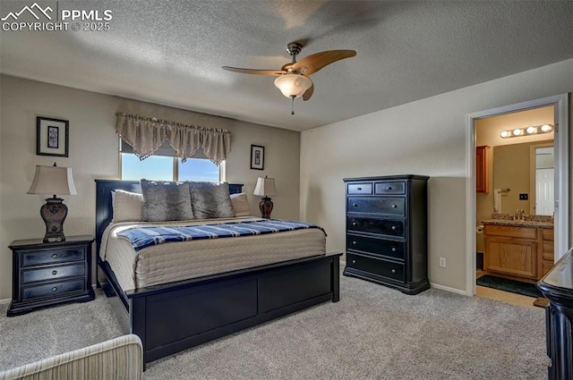 carpeted bedroom featuring connected bathroom, sink, a textured ceiling, and ceiling fan