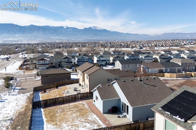 snowy aerial view with a mountain view