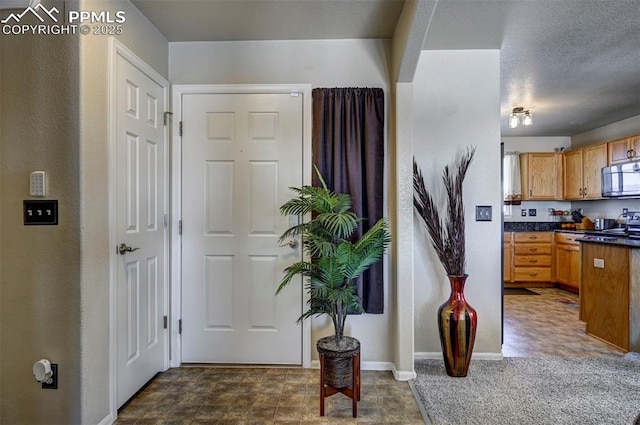 interior space featuring stove and a textured ceiling