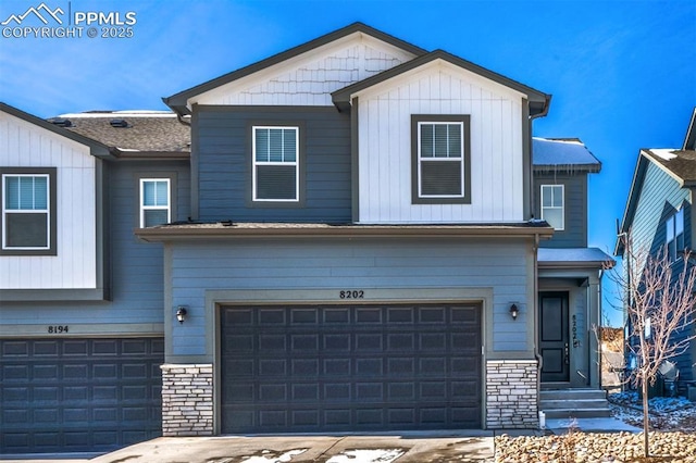 view of front of house featuring board and batten siding, stone siding, and an attached garage