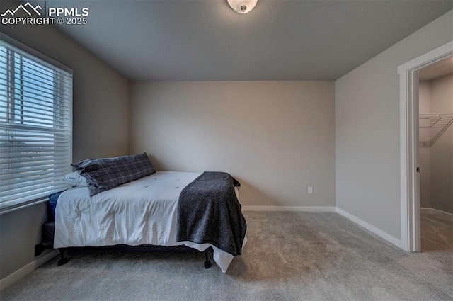 bedroom with light colored carpet and baseboards