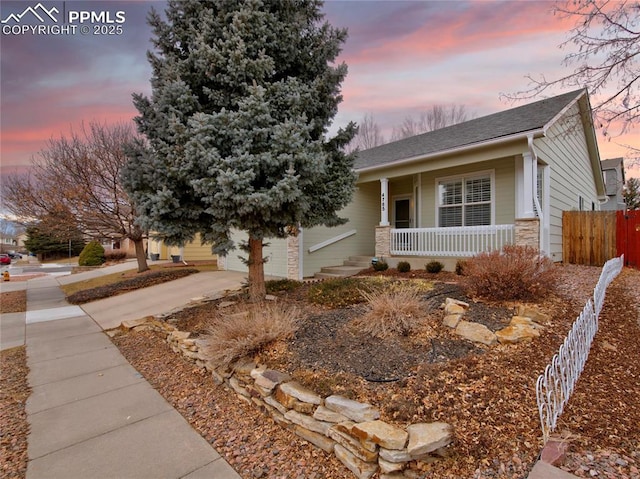 view of front of home featuring covered porch and a garage