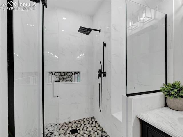 bathroom with vanity and a shower with door