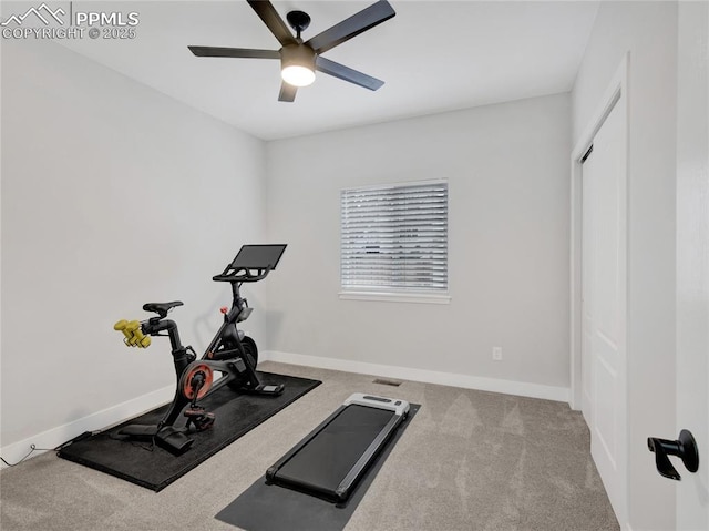 exercise room with ceiling fan and light colored carpet