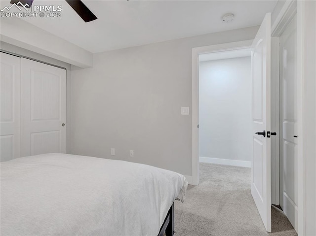 carpeted bedroom featuring a closet and ceiling fan