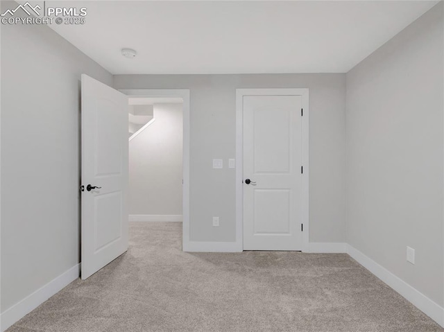 unfurnished bedroom featuring light colored carpet