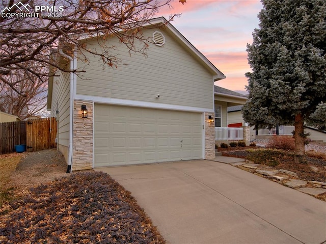 property exterior at dusk with a garage