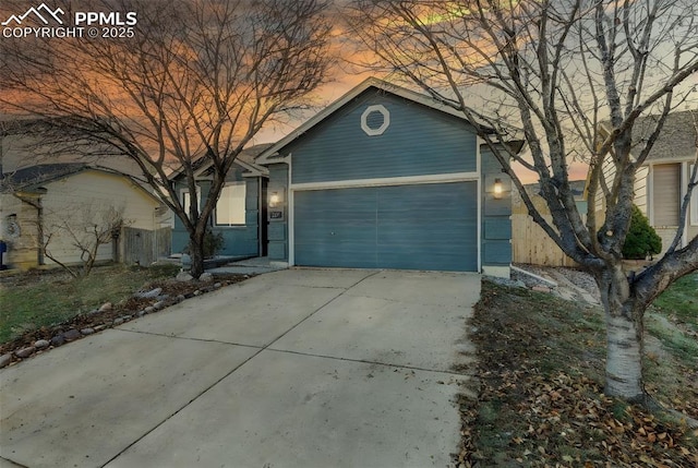 ranch-style house featuring a garage and driveway